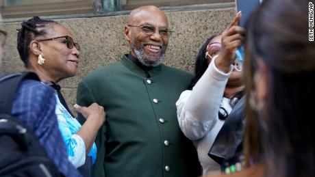 Muhammad Aziz, in the middle, poses for pictures outside the courthouse in New York with members of his family after his conviction for the murder of Malcolm X was abandoned on Thursday, November 18th.