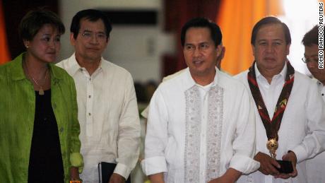 International evangelist Pastor Apollo Quiboloy (2nd R) walks with presidential candidates attending his 60th birthday celebration in Davao City, southern Philippines on April 25, 2010.