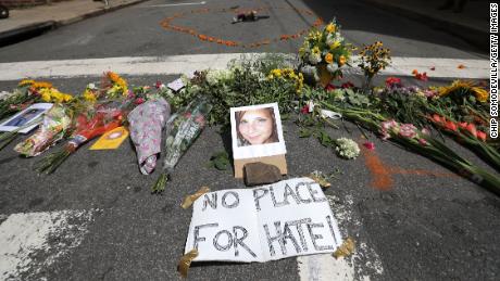Flowers surround a photo of Heather Heyer, 32, who was killed when a car plowed into a crowd protesting against a rally by the white far-right Unite the Right party, Aug. 2017 in Charlottesville, Virginia. 