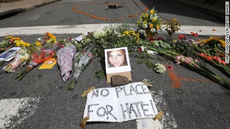 Flowers surround a photo of 32-year-old Heather Heyer, who was killed when a car plowed into a crowd of people protesting against the white supremacist Unite the Right rally, August 13, 2017 in Charlottesville, Virginia. 