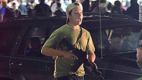 Kyle Rittenhouse carries a rifle in  Kenosha, Wisconsin, on August 25, 2020, during a night of unrest following the police shooting of Jacob Blake. Rittenhouse shot three people, two fatally, that night but was acquitted this week after claiming self-defense.