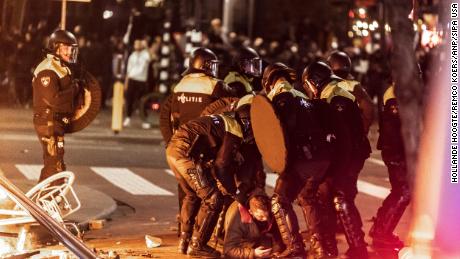 The unrest in Rotterdam on Friday involved several hundred protesters, the torching of cars and police vehicles being damaged. 