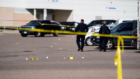 Evidence markers dot the parking lot of Hinkley High School in Aurora, Colorado, on November 19, 2021.