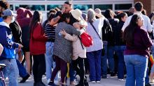 Parents are reunited with their children outside Hinckley High School in Aurora, Colorado on November 19, 2021.