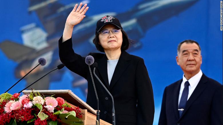 Taiwan President Tsai Ing-wen waves as Defence Minister Chiu Kuo-cheng looks on during a ceremony at the Chiayi Air Force in southern Taiwan on November 18, 2021.