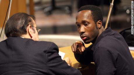 Rudy Guede (R) speaks with his assistant attorney at the Perugia court on November 18, 2009.