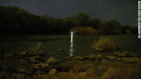 A light shines from an inflatable boat used to ferry migrants to the United States from the Mexican side of the Rio Grande. 