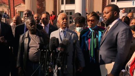 Wanda Cooper-Jones stands between Father Al Sharpton, center, and attorney S. Lee Merritt outside court Wednesday.