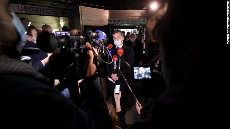 French Interior Minister Gerald Darmanin speaks to the press in front of a hospital in Calais, northern France, after at least 27 people died off the city's coast.