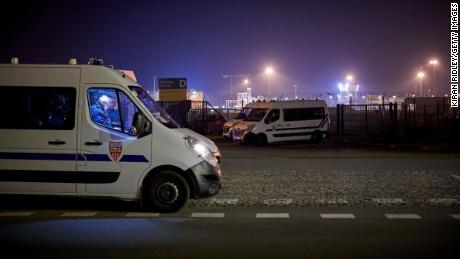 Police seal off the area around the rescue operation at France&#39;s Calais harbor on November 24.