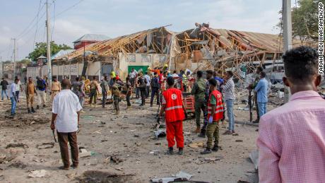 Security forces and rescue workers search for bodies at the scene of a blast in Mogadishu, Somalia Thursday, Nov. 25, 2021. Witnesses say a large explosion has occurred in a busy part of Somalia&#39;s capital during the morning rush hour. (AP Photo/Farah Abdi Warsameh)