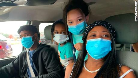 Tiffany Bernard, right, picks up food from the George R. Brown Convention Center in Houston with three of her five children. 