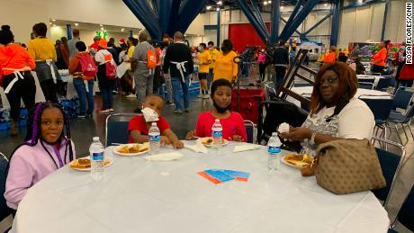 Kimberly Stubblefield, right, gets a Thanksgiving a meal with her three grandchildren as part of the 43rd annual &quot;Super Feast&quot; in Houston. 