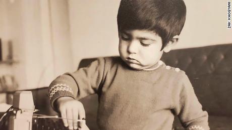Zak Khogyani playing with a camera as a boy in Afghanistan. He came to the US with his parents when he was 9.
