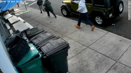 Security footage shows the woman, in the dark jacket, running away from her attacker in the grey top. 