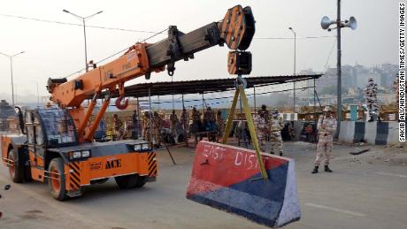 Delhi police erect a concrete barrier at the Delhi-Ghazipur border ahead of a farmer's protest on Friday.