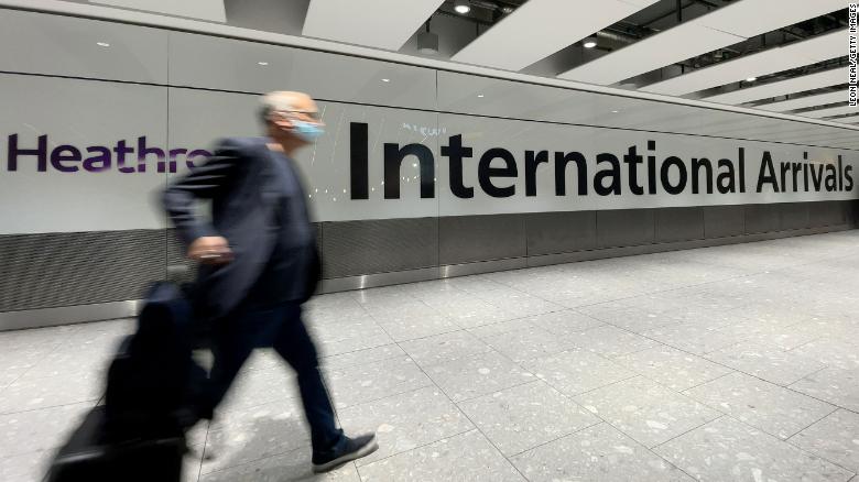 Passengers walk through the arrivals area at London&#39;s Heathrow Airport on November 26, after the UK suspended flights from several nations in southern Africa.