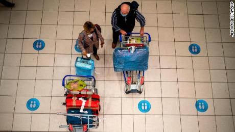 People wait at OR Tambo&#39;s airport in Johannesburg, South Africa&#39;, Friday Nov. 26, 2021. 