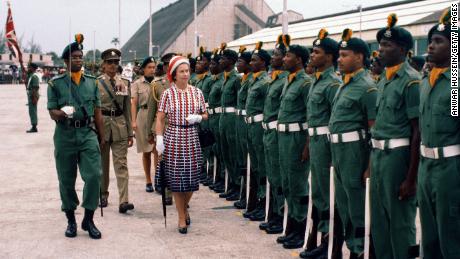 The Queen inspects an honor guard upon arrival in Barbados on 31 October 1977.