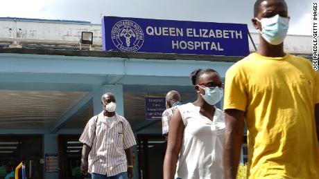 People walk through the entrance of Queen Elizabeth Hospital in Bridgetown, Barbados. 