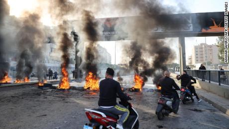 Burning tires set up by protesters to block a road in the capital Beirut on November 29.