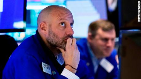 Specialist Meric Greenbaum, left, works at his post on the floor of the New York Stock Exchange, Friday, Nov. 26, 2021. 