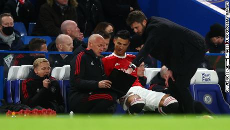 Cristiano Ronaldo of Manchester United takes instructions as he prepares to come on as a substitute during the Premier League match between Chelsea and Manchester United at Stamford Bridge on November 28, 2021 in London.