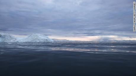 Rain falls in the distance on September 4, off the coast of Ilulissat, Greenland.