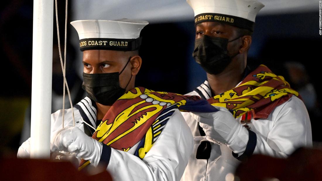 Members of the Barbados Coast Guard remove The Queen&#39;s Royal Standard flag at the Presidential Inauguration Ceremony.