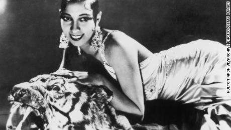 circa 1925:  Portrait of American-born singer and dancer Josephine Baker (1906 - 1975) lying on a tiger rug in a silk evening gown and diamond earrings.  (Photo by Hulton Archive/Getty Images)
