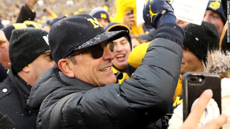 Michigan football coach Jim Harbaugh says he will gift his bonus to staffers who took pay cuts