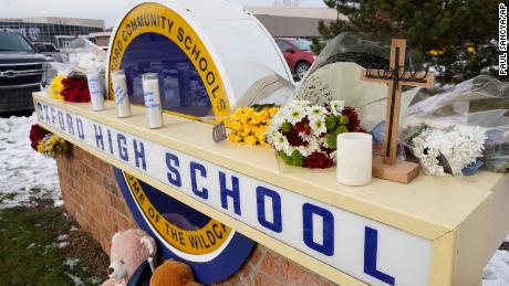 Memorial items are shown on the sign of Oxford High School in Oxford, Mich., Wednesday, Dec. 1, 2021. A 15-year-old sophomore opened fire at the school, killing several students and wounding multiple other people, including a teacher. (AP Photo/Paul Sancya)