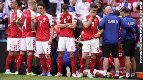 Denmark&#39;s players react as paramedics attend to Eriksen after he collapsed on the pitch in June, 2021.