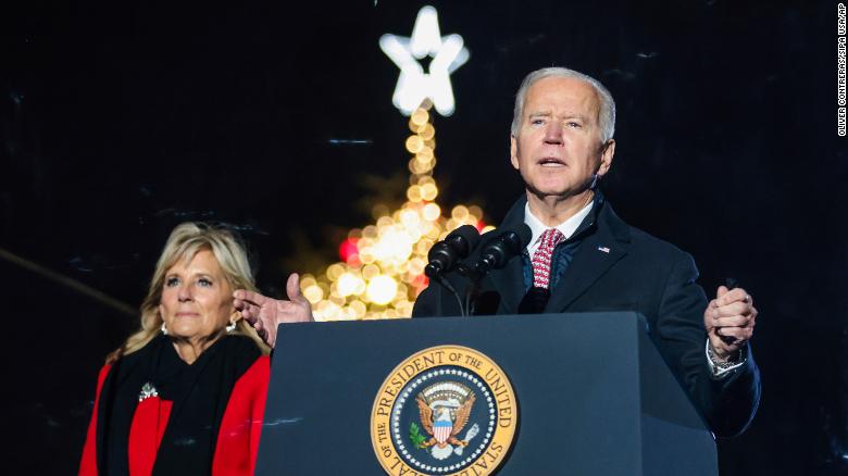 First lady Jill Biden joins President Joe Biden on stage as he delivers remarks during the National Christmas Tree Lighting ceremony held at the Ellipse near the White House on December 2, 2021. 