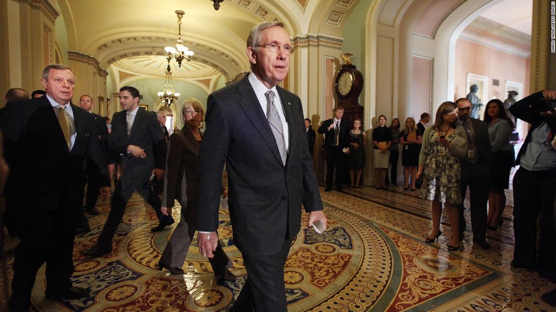 Reid walks over to the media after voting on a bill to raise the debt ceiling in 2011.