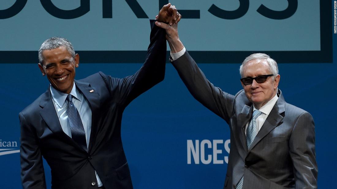 Reid holds up Obama's hand after the President delivered a keynote address at the National Clean Energy Summit in Las Vegas in 2015.