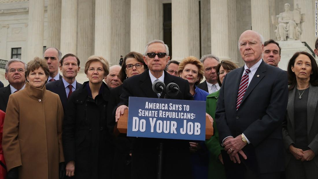 Reid joins other Senate Democrats in front of the Supreme Court in 2016 as they demanded that Senate Republicans hold confirmation hearings for President Obama's new Supreme Court nominee. GOP leaders in the Senate said they would not hold a confirmation hearing after Obama said he would name someone to replace Associate Justice Antonin Scalia, who died earlier that month while on a hunting trip in Texas.
