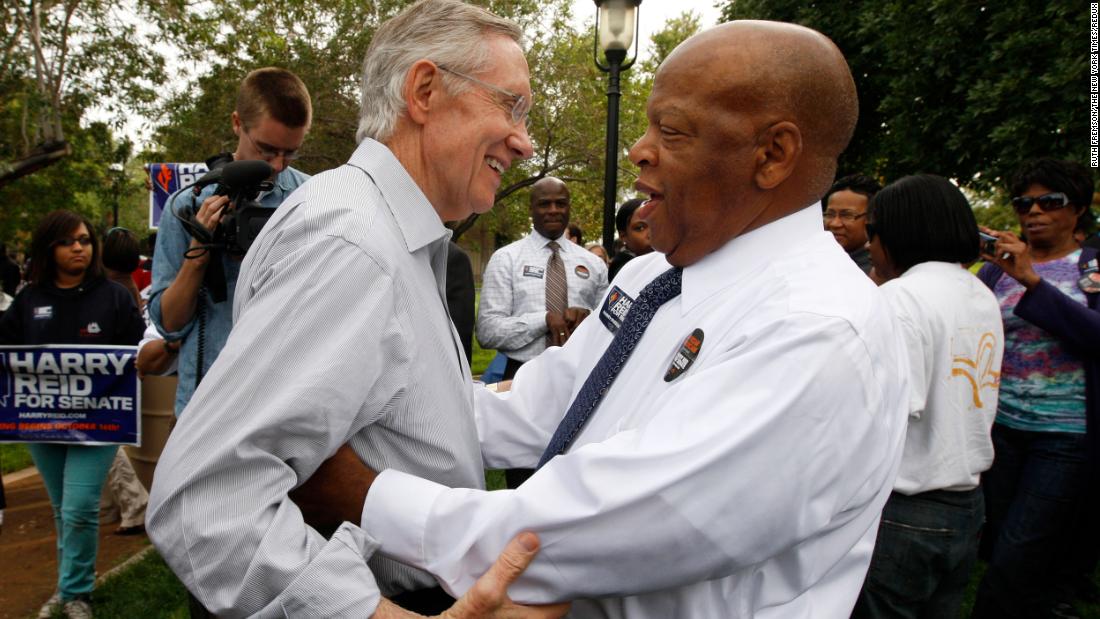 Reid greets US Rep. John Lewis at a campaign barbecue in Las Vegas in 2010.