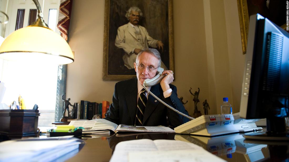 Reid talks at his desk in the Capitol in 2008.