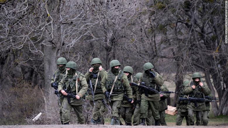 Russian soldiers patrol the area surrounding the Ukrainian military unit in Perevalnoye, outside Simferopol, Crimea, on March 20, 2014.