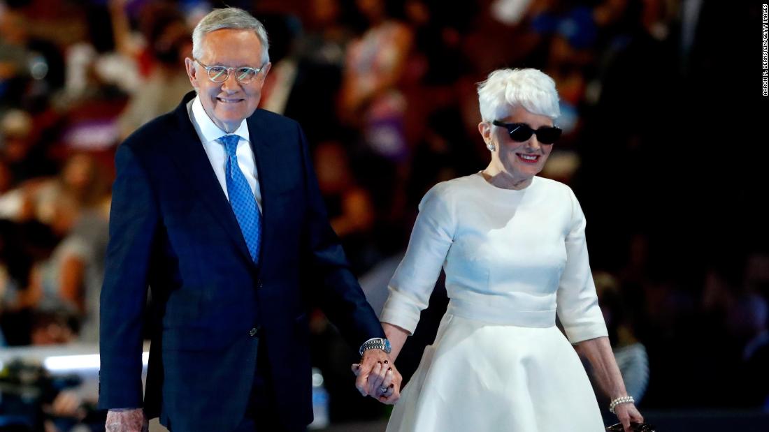 Reid and his wife, Landra, walk off stage after Reid spoke at the Democratic National Convention in 2016. Reid retired the next year.
