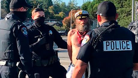 This photo provided by the Santa Cruz Police Department shows Ole Hougen being taken into custody by police officers in Santa Cruz, Calif., last year.