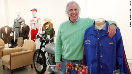 Actor Henry Winkler poses with items from his collection that are going up for auction in Los Angeles.