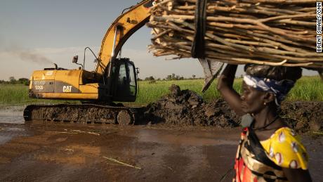 A UN mission repairs a damaged dike.