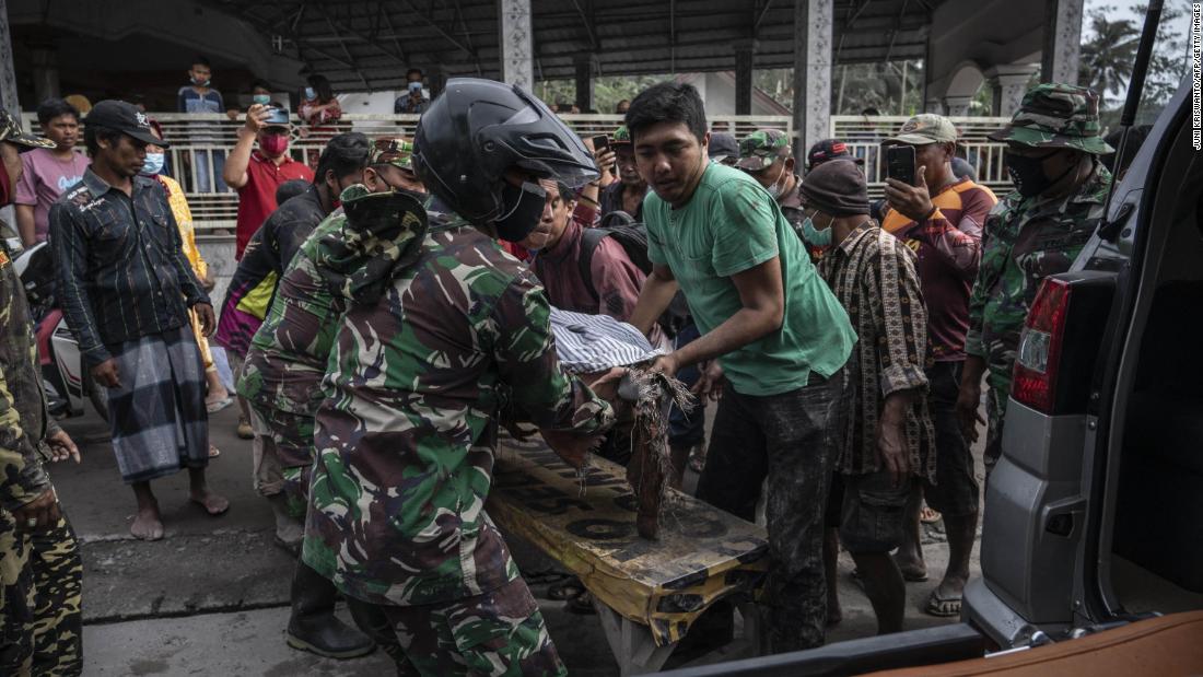 Rescue workers transport a victim in Sumberwuluh on Sunday.