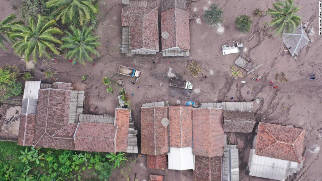 This aerial photo, taken on Monday, shows houses and trucks covered by ash in Sumberwuluh.