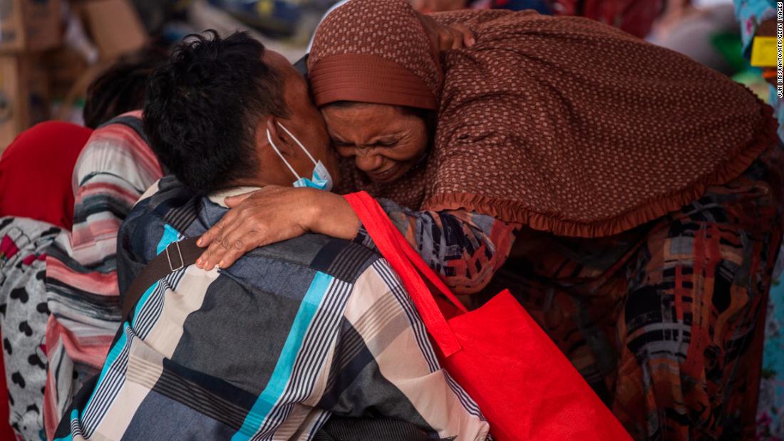 Villagers gather at a makeshift shelter in the Sumberwuluh village on Monday.