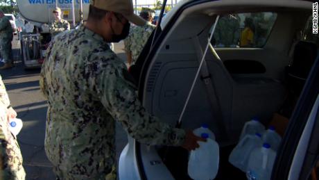 US Navy servicemembers hand out potable water amid water crisis at Joint Base Pearl Harbor-Hickam.