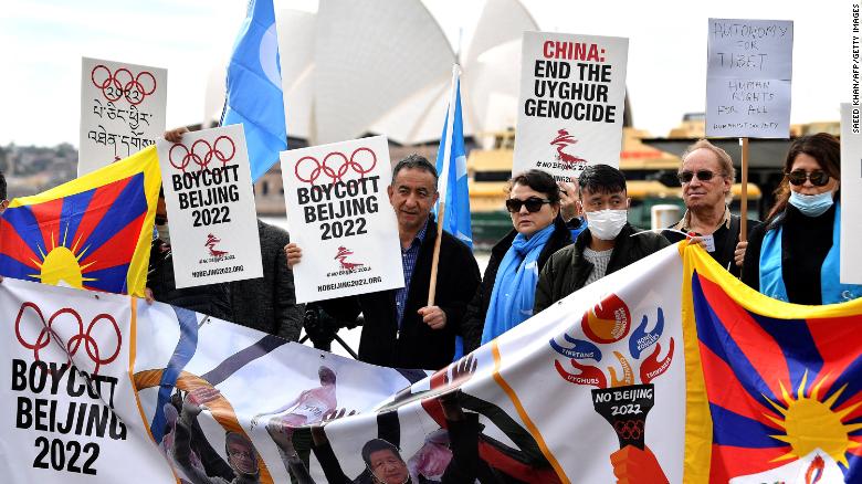 Protesters hold up placards and banners as they attend a demonstration in Sydney on June 23, 2021 to call on the Australian government to boycott the 2022 Beijing Winter Olympics over China&#39;s human rights record.