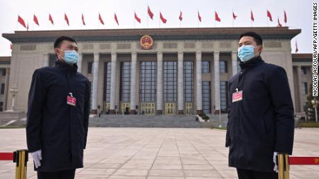 Security personnel stand guard outside the Great Hall of the People ahead of the closing session of the National Peoples Congress in Beijing on March 11.